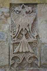 A historical building framed with artistically carved stonework. Architectural detail from the Divriği Great Mosque and Hospital, listed on the UNESCO World Heritage List. Floral and geometric motifs.