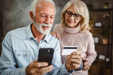 senior husband and wife buy online on cellphone with credit card