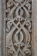 A historical building framed with artistically carved stonework. Architectural detail from the Divriği Great Mosque and Hospital, listed on the UNESCO World Heritage List. Floral and geometric motifs.