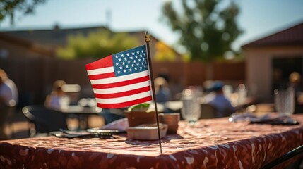 A red and white American flag is on a table in front of a group of people