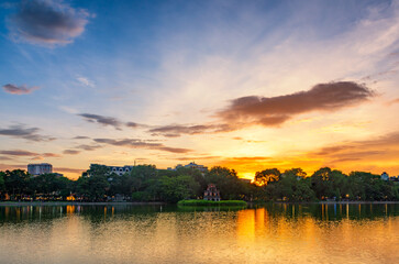 Hoan Kiem Lake ( Ho Guom) or Sword lake in the center of Hanoi in cinematic sunset sky.
