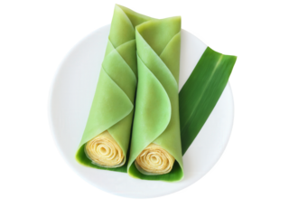 Dadar Gulung, pandan-flavored crepes filled with grated coconut and palm sugar, rolled and sliced, served on banana leaf, Indonesian delicacy,
