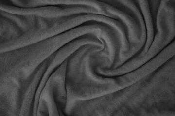 Texture of Dark grey crumpled textile cloth part with small folds