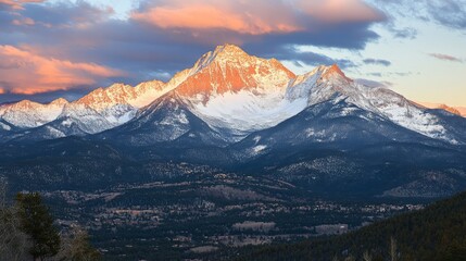 Majestic Sunrise Over Snow-Capped Mountain Peaks with Vibrant Clouds Reflecting Soft Morning Light in the Rocky Mountains