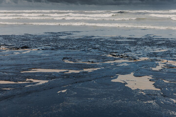 Oil leak in sea coastline after a tanker wreck. Oil fuel polluted and destroy beach