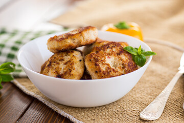 fried chicken cutlets in a bowl on a wooden table