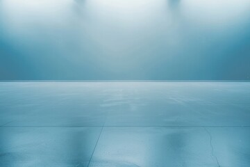 Empty blue space with soft lighting and a reflective surface ideal for backgrounds.
