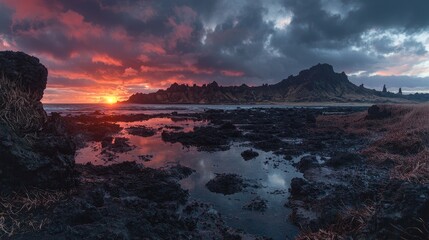 Fototapeta premium Vibrant sunrise over dramatic volcanic coastline, reflecting in tide pools.