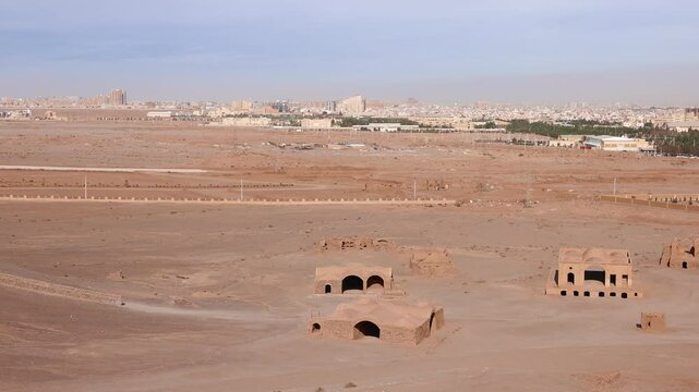 Ruins of ritual buildings next to Zoroastrian Dakhma Towers of Silence in Yazd city, Iran. Tourist walk around remains of Zoroastrians Dakhmeh Towers of Silence area in Yazd city.