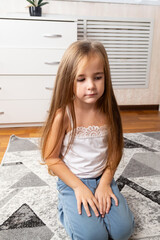 Fototapeta premium little girl sitting on your room in the morning
