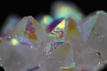 A rainbow aura quartz crystal cluster radiates vibrant, iridescent hues, combining natural beauty with mystical energy and gemstone brilliance, isolated in studio