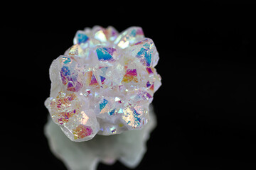 A rainbow aura quartz crystal cluster radiates vibrant, iridescent hues, combining natural beauty with mystical energy and gemstone brilliance, isolated in studio