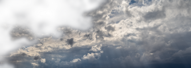 Panorama of storm cloud filled sky with the dark clouds fading to transparent top left

