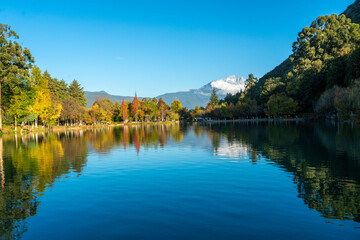 The park has morning activities. Black Dragon Pool is a park where in the morning you can see the reflection of the Jade Dragon Snow Mountain in the pond in Lijiang City, China.