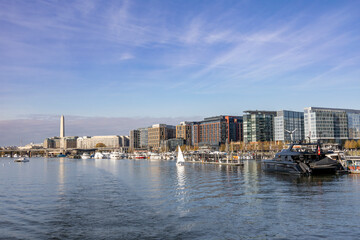 View from the ferry between Washington DC and Alexandria, showcasing a scenic waterfront and modern cityscape.