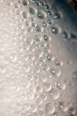 Close Up of Condensation Floating Liquid Water Bubbles and Drips on Glass from Rain