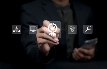 businessperson working on with sign of the top service Quality control certification checked guarantees of the standard of company product. Concept on virtual screen.