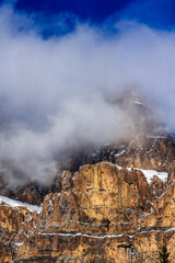 A mountain range covered in snow and clouds