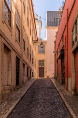 The narrow alleys and old buildings of the Alfama neighborhood in Lisbon in the late afternoon