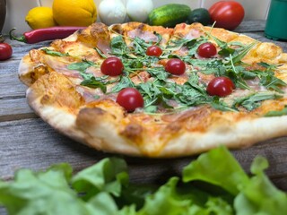 Home made pizza with cherry tomatoes and mozzarella cheese.  High-quality photo