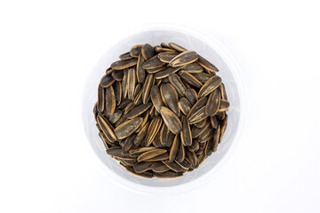 Dark brown striped sunflower seeds isolated on a white background