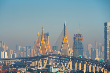 Fototapeta premium The Bhumibol Bridge across the Chao Phraya River and skyscrapers in Bangkok city