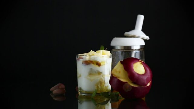 sweet homemade yogurt in a glass with apples, nuts and honey