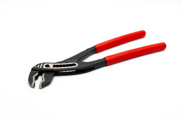 Adjustable black pliers with red rubber handles isolated on a white background, showcasing ergonomic design for gripping, repairing, and mechanical work, suitable for construction or DIY tasks.