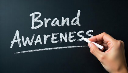 Fototapeta premium Hand holding white chalk writing Brand Awareness.Highlighting key business principles.