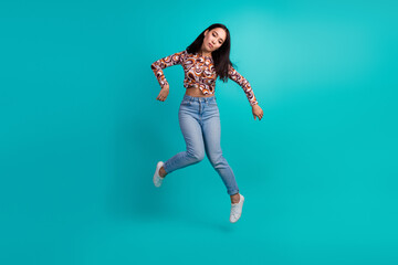 Full body portrait of nice young girl doll hang air isolated on turquoise color background