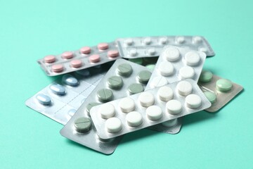 Various blisters with tablets on a colored background