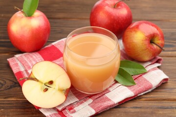 Tasty apple juice and fresh fruits on wooden table, closeup