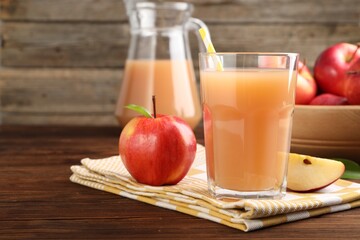 Tasty apple juice and fresh fruits on wooden table, closeup