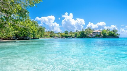 Fototapeta premium Idyllic tropical beach with turquoise water, lush greenery, and a house on a hill.