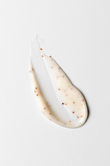 A sample of a cosmetic body care scrub. White background.