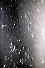 Close Up of Heavy Rain Floating Liquid Water Bubbles and Drips Black Background