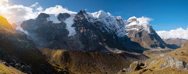 Panoramic photo Mera peak 6476m with glacier lakes and snowy summits covered in white clouds. Himalayas climbing route near the Khare settlement, Makalu Barun National Park trek in Nepal.