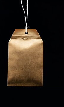 A simple, hanging gold tag against a black background, often used for labeling or branding.
