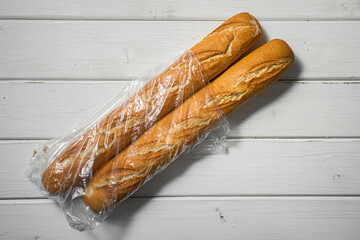 Fresh baguette on a light table. Fresh bread product