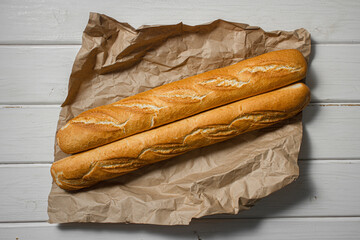 Fresh baguette on a light table. Fresh bread product
