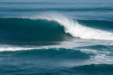 Powerful ocean wave breaking in the deep blue sea