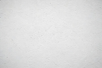 White textured plaster wall background showing brush strokes and imperfections