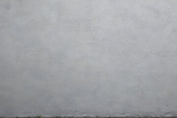 Fototapeta premium Gray concrete wall background texture with a small curb showing signs of wear