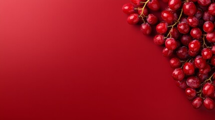 A bunch of red grapes on a red background