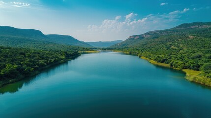 Serene River Landscape: Lush Green Forest and Majestic Mountains Reflecting in Tranquil Waters