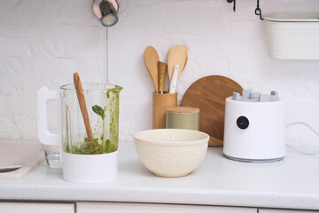 A bright kitchen with a powerful dirty blender, mixing bowl, and utensils, ideal for healthy...