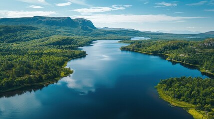 Obraz premium Serene Lake Amidst Lush Green Hills: An Aerial View of Tranquil Nature's Embrace