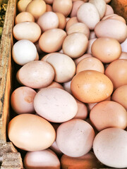 Pile of chicken eggs in a wooden box