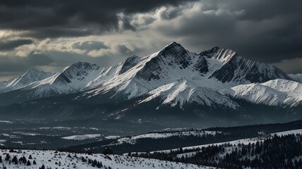 Obraz premium Majestic Snow-Capped Mountain Range Under Stormy Skies