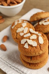 Tasty cookies with almond flakes and nuts on table, closeup